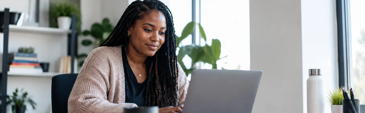 Canadian business professional working at a laptop in a bright office