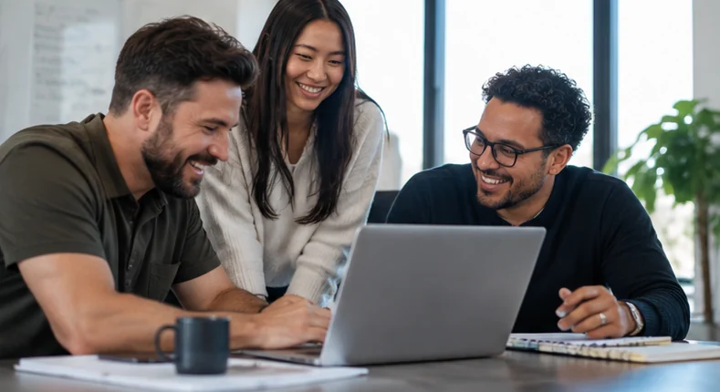 Small-business team collaborating around a laptop